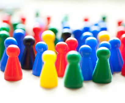 A bunch of colorful game pieces sitting on top of the table.