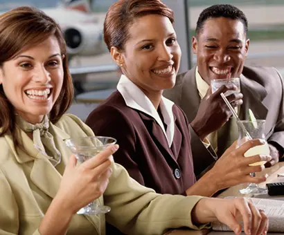 A group of people sitting at a table with wine glasses.