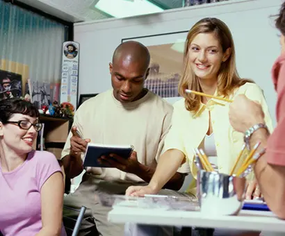 A group of people sitting around a table.