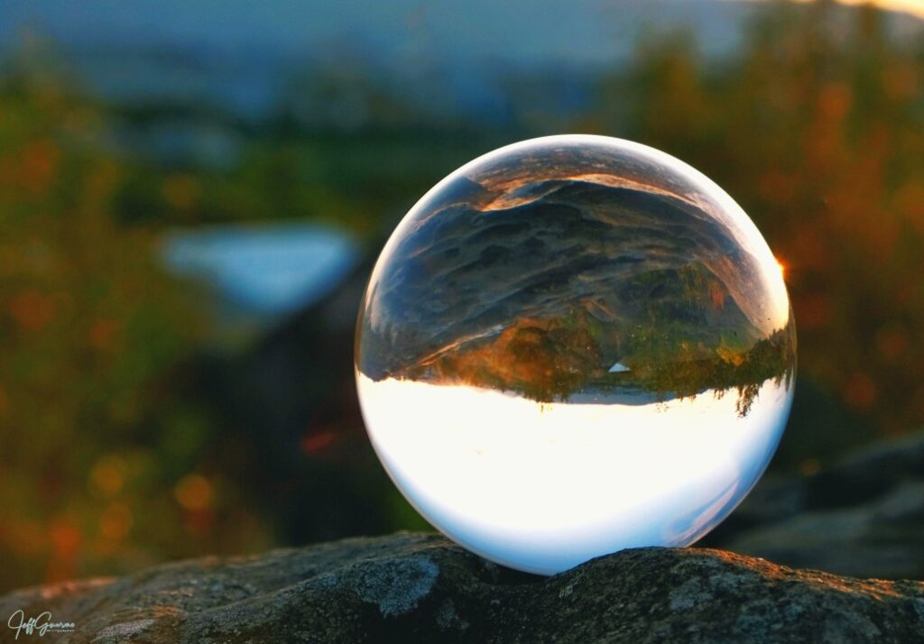 A crystal ball sitting on top of a rock.